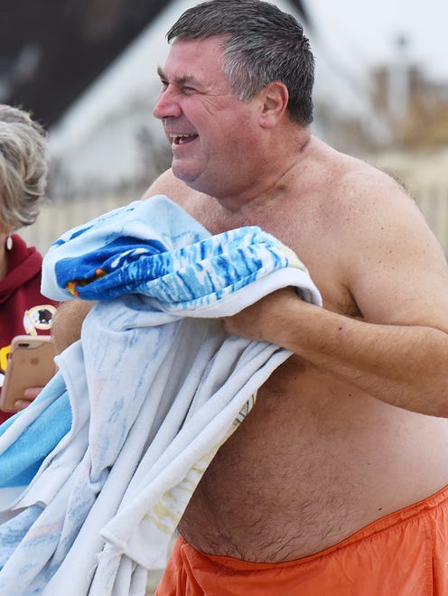 About thirty people braved the cold and made the plunge into the ocean at Dagsworthy Street in Dewey Beach on Sunday as the postponed "Dewey Dunk" was finally held after being postponed due to frigid conditions in January.
