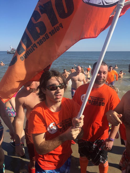 Ian Snitch, a senior at Middletown High School, led MHS Team Chuck Orange into the cold Atlantic Ocean on Sunday during the 26th annual Special Olympics Lewes Polar Bear Plunge at Rehoboth Beach.