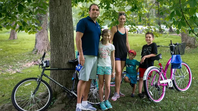 Victor and Christi David of Newark and their three children, Natalia (age 8), Rhys (age 3), and Remy (age 7), enjoy the Bike & Hike event at Hagley Museum in Wilmington.