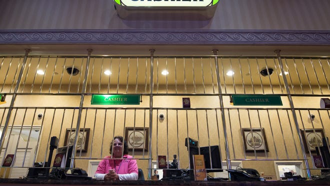 A cashier works at Dover Downs Hotel & Casino in Dover on May 27.
