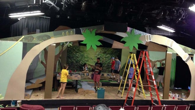 Participants in the Possum Juniors program build the set for their production of "The Jungle Book."