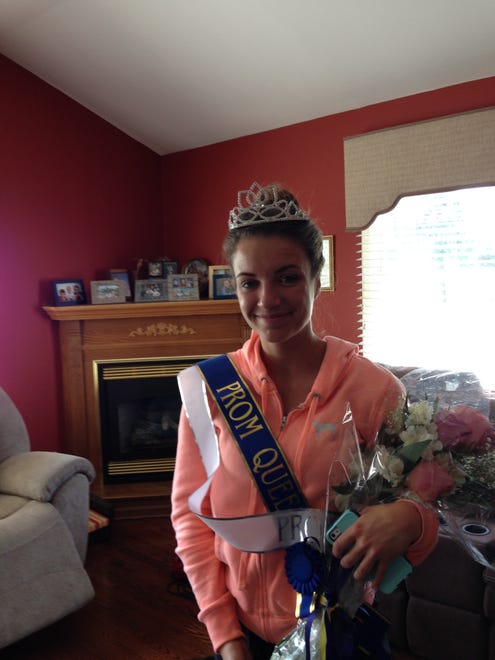 Sarah Godek shows her grandparents her crown and sash after winning prom queen at Delaware Military Academy in 2015.