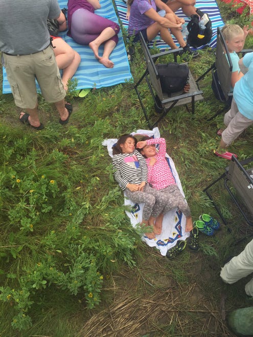 Lucia and Olivia Benevento, 8, of Long Island, NY wait sleepily for the Pony Swim.