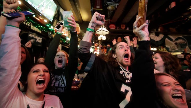 Fans react to an Eagles touchdown during Super Bowl 52 between the Philadelphia Eagles and the New England Patriots, Sunday, Feb. 4, 2018, in Philadelphia.