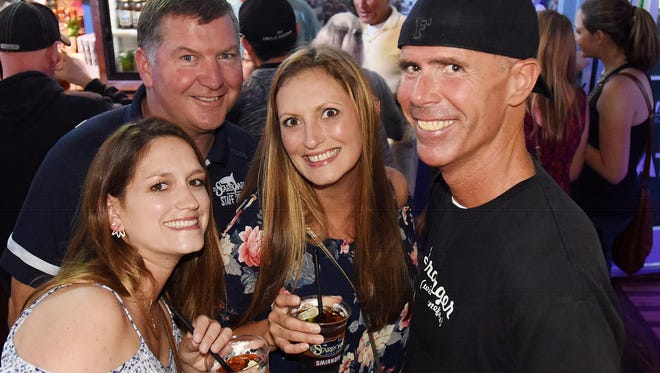 Laura Balback, Jenn Simon and Eric Feazel have a photo taken as Steve "Monty" Montgomery co-owner of the Starboard in Dewey Beach works the bar and crowd at his establishment along Coastal Highway and Saulsbury Street.
Special to the News Journal / CHUCK SNYDER