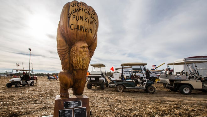The World Championship Punkin Chunkin trophy sits near the air cannons at the 2016 World Championship Punkin Chunkin competition at Wheatley Farms in Bridgeville on Sunday afternoon.