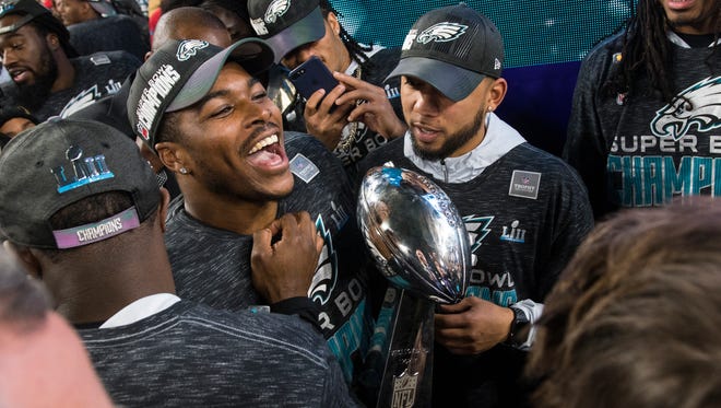 The Eagles' Corey Clement holds the Vince Lombardi Trophy Sunday at US Bank Stadium.