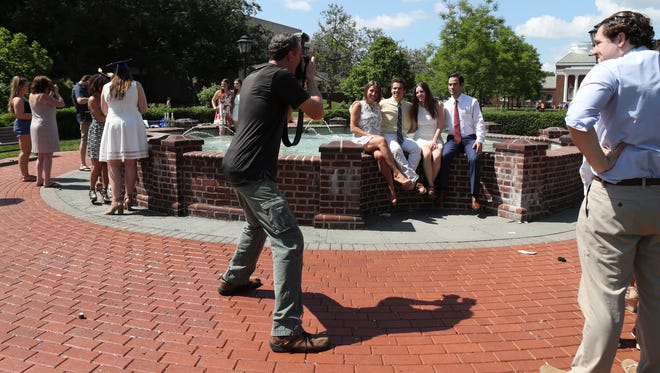 Not everyone who visits the fountain enters it, but plenty do in the "bucket list" experience for University of Delaware students in the days before graduation.