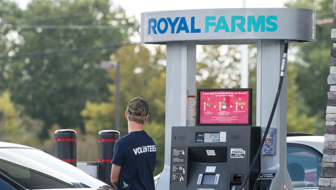 A man pumps gas at a Royal Farms on the corner of Beaglin Park Drive and Snow Hill Road.