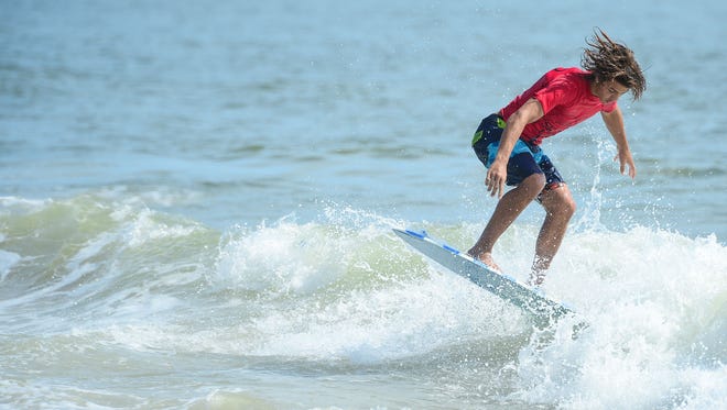 Mason Broussard, Gulf Shores, AL, catches a wave during the Men's Pro Division heat in the semifinals of the Skim USA Association ZAP Pro/Am Skimboarding Competition in Dewey Beach, De. on Friday,  August 11, 2017.