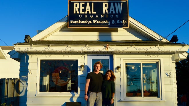 Logan Willey, owner of Real Raw Organics, is shown with her boyfriend in front of the shop.