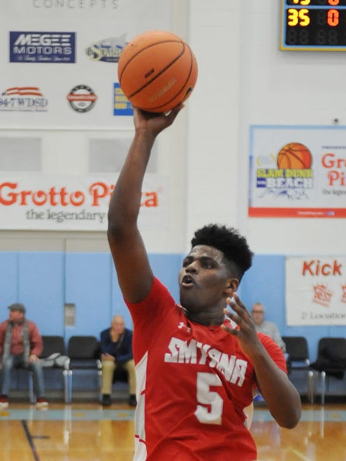 Smyrna's #5 Jaymeir Garnett goes for a basket as Smyrna High School (red) defeated Howard High School (white) 86-53 in the opening game of the Slam Dunk to the Beach Tournament held at Cape Henlopen High School on Wednesday December 27th. 
Special to the News Journal / CHUCK SNYDER