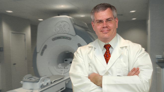 A view of a doctor with an MRI machine.