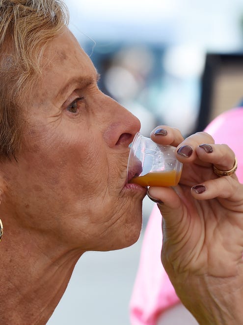 Thelma Williams from Bethany Beach drinks a sample from "Juice Fresh" in Rehoboth Beach.
