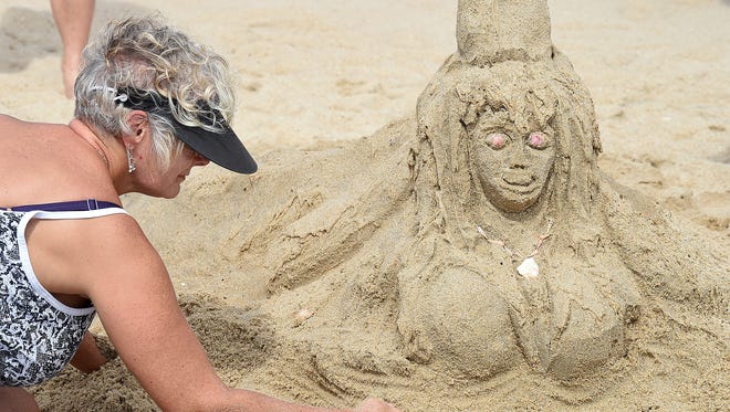 Sheri Miller from Boyertown, PA. puts finishing touch's on her sculpture as The 38th Annual Rehoboth Beach-Dewey Beach Chamber of Commerce Sandcastle Contest was held on Saturday, Sept. 10, 2016 at a new location on the south end of the beach near Funland under hot weather conditions.  Participants worked to create different castles and sculptures in the sand for judging in the late afternoon at which time trophy's ail be given out.