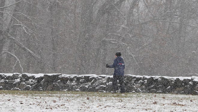 A cross country skier takes to Brandywine Creek State Park as snow begins to drape the area Saturday morning.