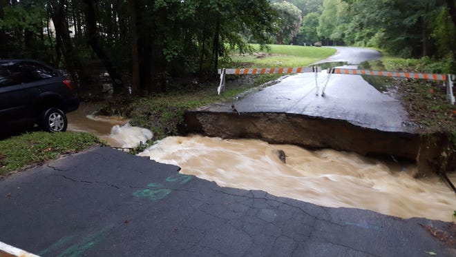Flooding damaged roads and forced evacuations in Salisbury on Saturday after heavy rains.