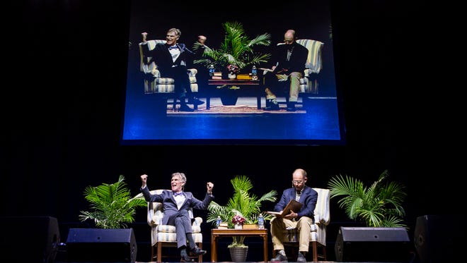 Bill Nye reacts to cheers from the crowd during a moderated discussion with Univeristy of Delaware professor McKay Jenkins (right) at the Bob Carpenter Center in Newark on Tuesday night.