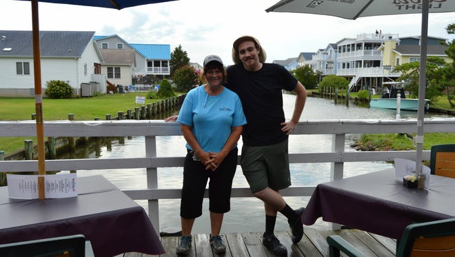 Linda Guckin, owner of Fin Alley in Fenwick, smiles with executive chef, Alex Ljuba.