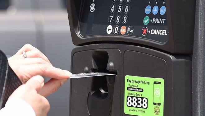 A credit card is inserted into a Rehoboth Beach parking meter. When meters started taking credit cards on May 27, they didn't include picture instructions on how to insert the card. Now they do.