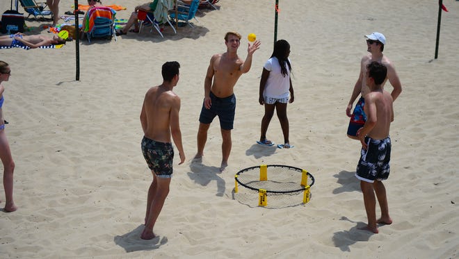 A group of people play Spike Ball on the beach in Bethany on July 3, 2017.