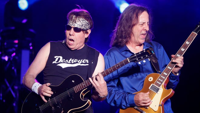 George Thorogood sidles up to guitarist Jim Suhler as he and the Destroyers play the Delaware State Fair Friday.
