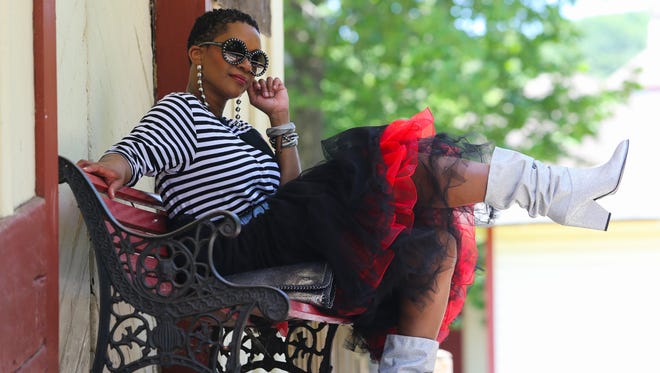 Lauren Simmonds is photographed at the Wilmington and Western Railroad station in Prices Corner Saturday, June 16, 2018. In this outfit Lauren is wearing sunglasses by Prada, earrings by Aldo, striped top by Blacktag Apparel, belt from Express, a combination of three skirts (for layering), boots by Stuart Weitzman and Phase 3 clutch.