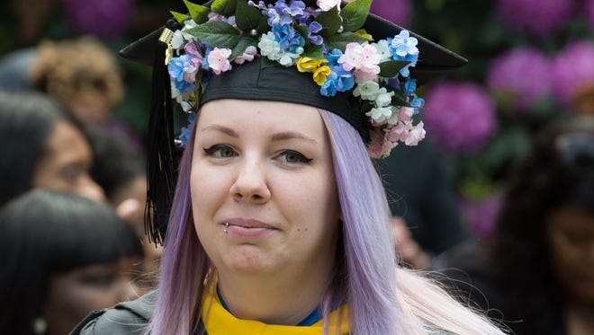 Graduate Emily Margaret Fiore with her flowered cap at the Wesley College Spring Commencement in Dover.  A total of 244 graduated.