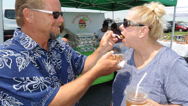 Duane Smith of Long Neck feeds his wife Connie some vegan cake from "Naturally Sweet Desserts" of Philadelphia.