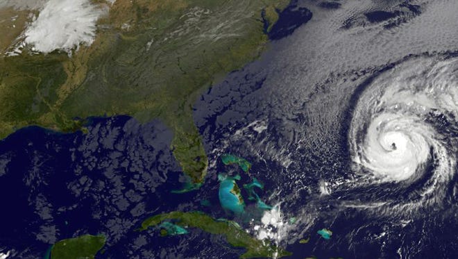 A satellite image shows Hurricane Nicole (right) roaring toward Bermuda on Oct. 12, 2016.