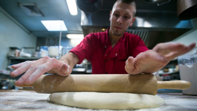 Pastry chef Dru Tevis methodically rolls donut dough in the kitchen of Bramble & Brine in Rehoboth Beach.