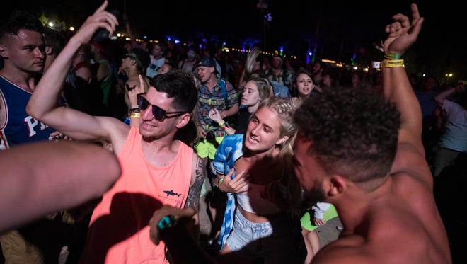 Festival goers dance to Eminem at the Firefly Stage during day 3 of Firefly Music Festival in Dover.