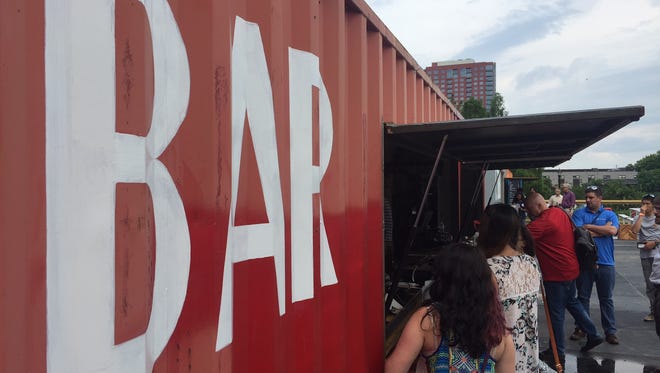 Customers stand in line for beer on opening day of the new Constitution Yards Beer Garden on Wilmington's Riverfront.