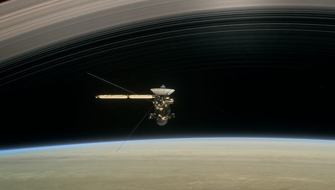 This image made available by NASA in April 2017 shows a still from the short film "Cassini's Grand Finale," with the spacecraft diving between Saturn and the planet's innermost ring. Launched in 1997, Cassini reached Saturn in 2004 and has been exploring it from orbit ever since.