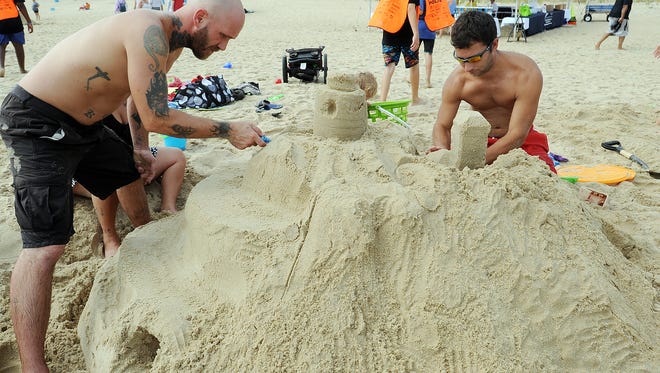 Jeff Fake and John Dundore from Lebanon, Pennsylvania, work on their castle as the 38th Annual Rehoboth Beach-Dewey Beach Chamber of Commerce Sandcastle Contest was held on Saturday Sept. 10 at a new location on the south end of the beach near Funland under hot weather conditions.  Participants worked to create different castles and sculptures in the sand for judging in the late afternoon at which time trophy's ail be given out.