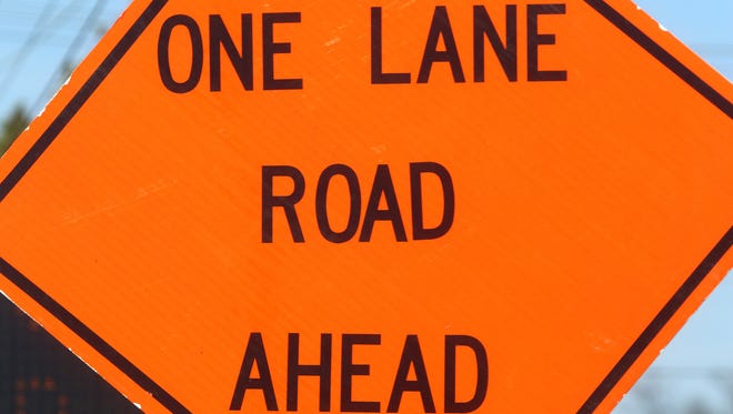 One Lane Road Ahead sign.