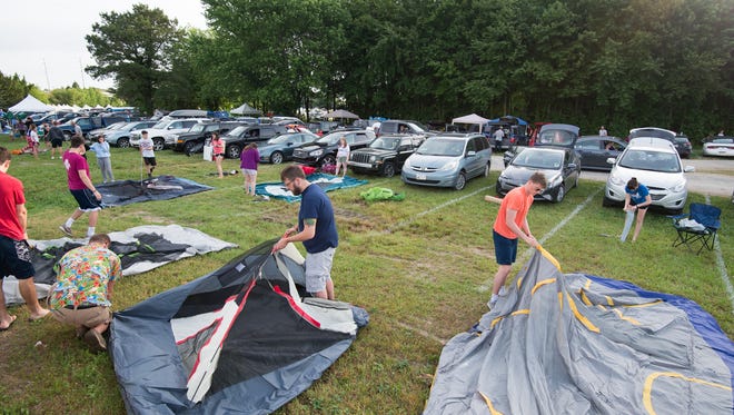 Campers set up their campsite early Thursday morning at the Firefly Music Festival in Dover.