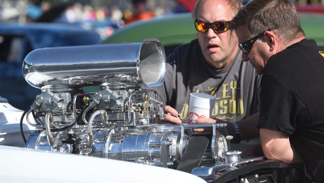 Ken Lentz, left, and Tom Collins, owner of the 1967 Chevy II Gasser, inspect the motor of the car at the convention center in Ocean City during Endless Summer Cruisin' 2017 on Saturday, Oct. 7, 2017.