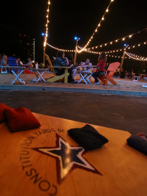 People relax during the first night of the Constitution Yards beer garden at the Wilmington Riverfront Friday.
