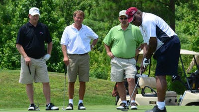 In this June 13, 2012 file photo, pro football Hall of Fame and University of Maryland Eastern Shore alumnus Art Shell putts while team members look on during the annual Art Shell Celebrity Golf Classic.
