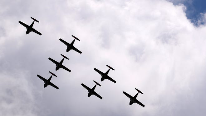 Canadian Forces Snowbirds jet team fly in formation over Willow Run Airport in Ypsilanti on Tuesday, June 21, 2016 surveying the airport and surrounding area before they came in for a landing.
