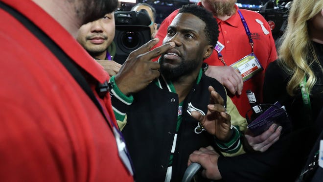 Comedian, Philidelphia native and Eagles fan Kevin Hart attempts to get onto the stage following the Eagles 41-33 win over the New England Patriots in Super Bowl LII at U.S. Bank Stadium on February 4, 2018.