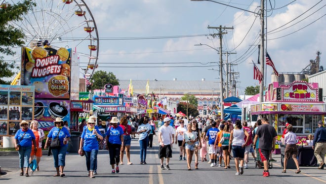Fairgoers make their way through the Delaware State Fairgrounds in Harrington on Thursday afternoon.