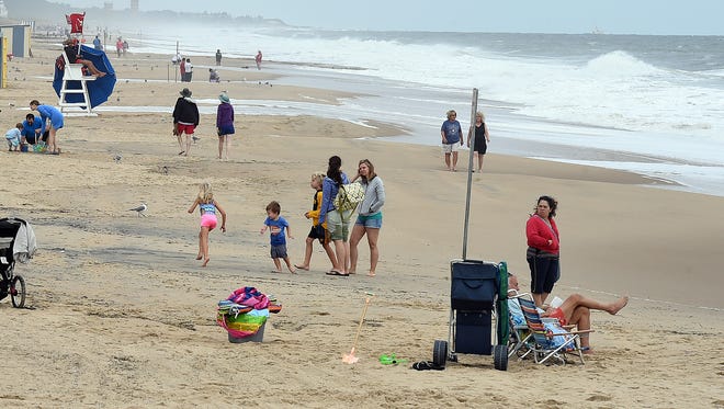 Beachgoers enjoy the sun and the sand under a light breeze on Monday at Rehoboth Beach. Hermine left without doing much damage to the area over the Labor Day weekend.