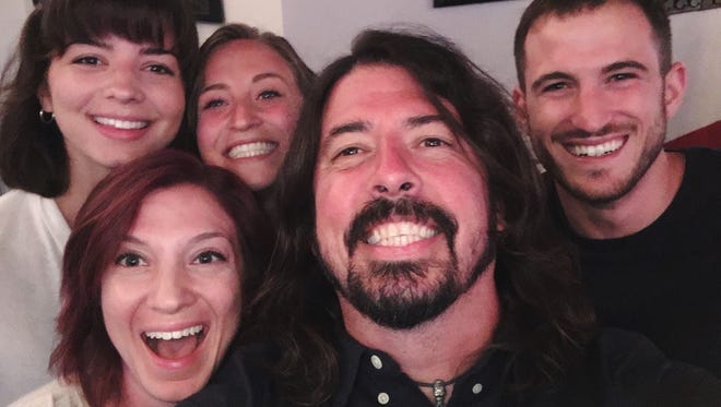 Dave Grohl takes a selfie with Crista Vizzoni (front left) and friends at The Crab House in Rehoboth Beach on Aug. 3.