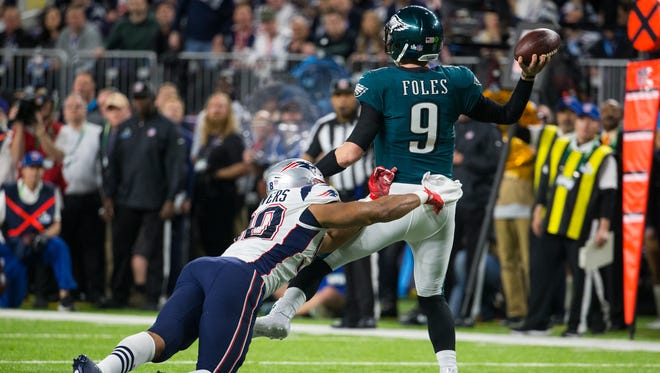 Eagles quarterback Nick Foles throws under pressure Sunday at US Bank Field in Super Bowl LII.