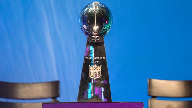 The Vince Lombardi Trophy sits on display at the Super Bowl Opening Night Monday at the Xcel Energy Center.