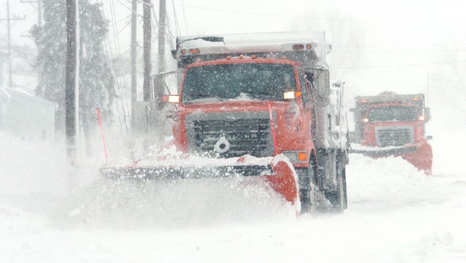 DelDOT snowplows work their way east along Rt. 14 near Milford in this file photo.