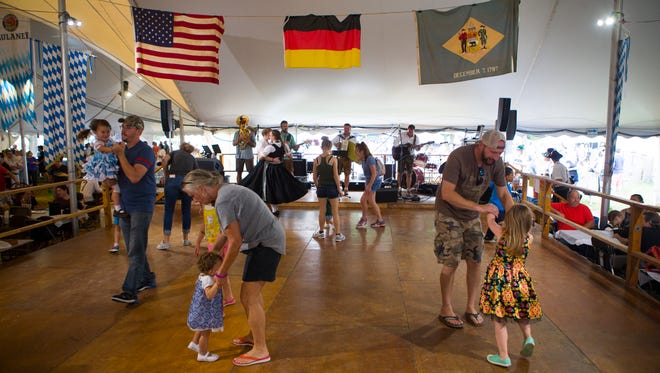 Little girls dance away with loved ones as Almwind performs on the dancing stage at The 2017 Delaware Saengerbund Oktoberfest in Newark.