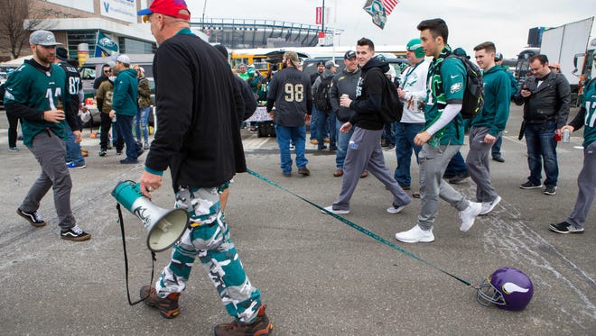 Davids Schofield of Telford, PA rolls around the parking lot "walking the dog" as Eagles fans begin their tailgating early Sunday morning in the NFC Championship game at Lincoln Financial Field.